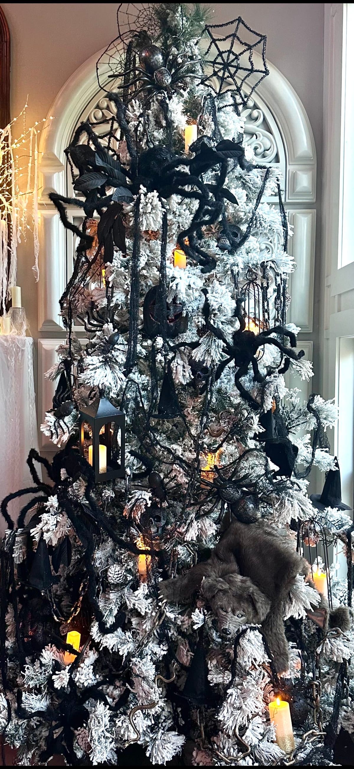 Flocked Halloween tree with black spiders, lanterns, and candles